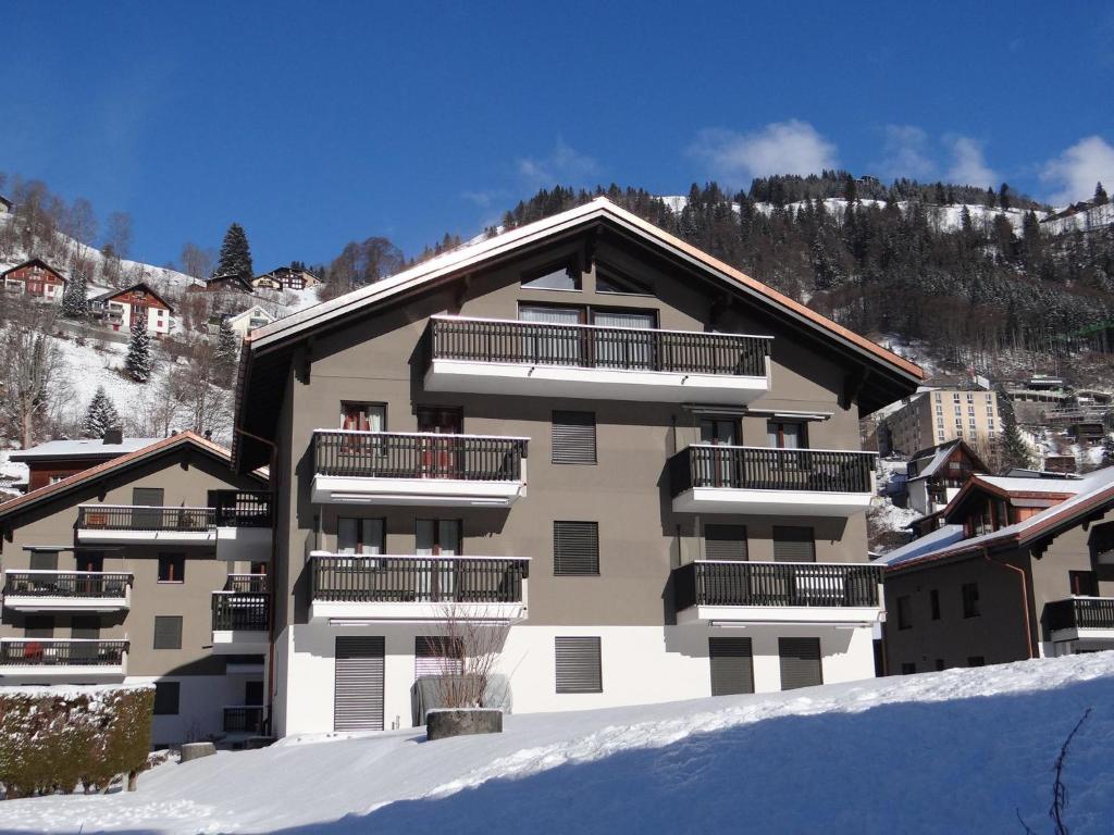 a apartment building with snow in front of it at Apartment Sörenweg 5 by Interhome in Engelberg