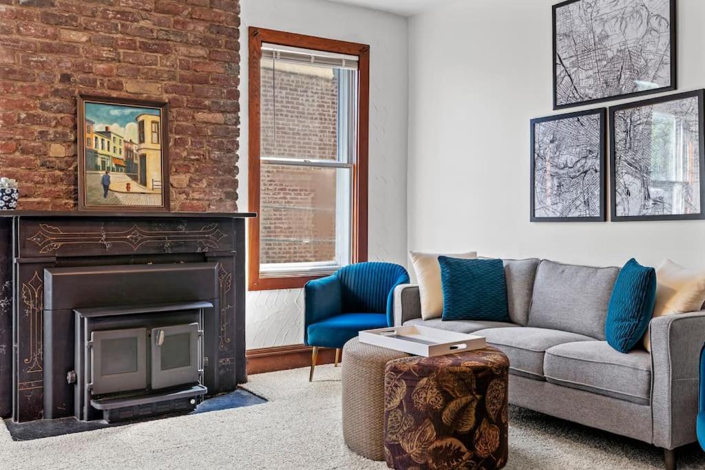a living room with a couch and a fireplace at Spacious Home in Heart of Historic Fan District in Richmond