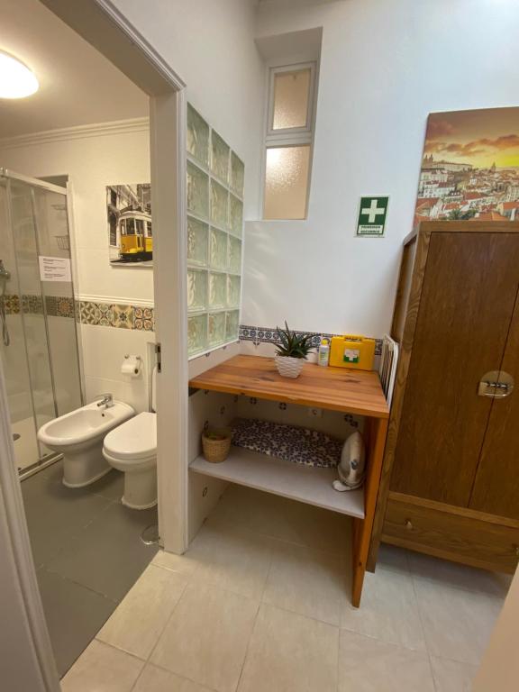 a bathroom with a toilet and a sink at Flat Graça 48 in Lisbon