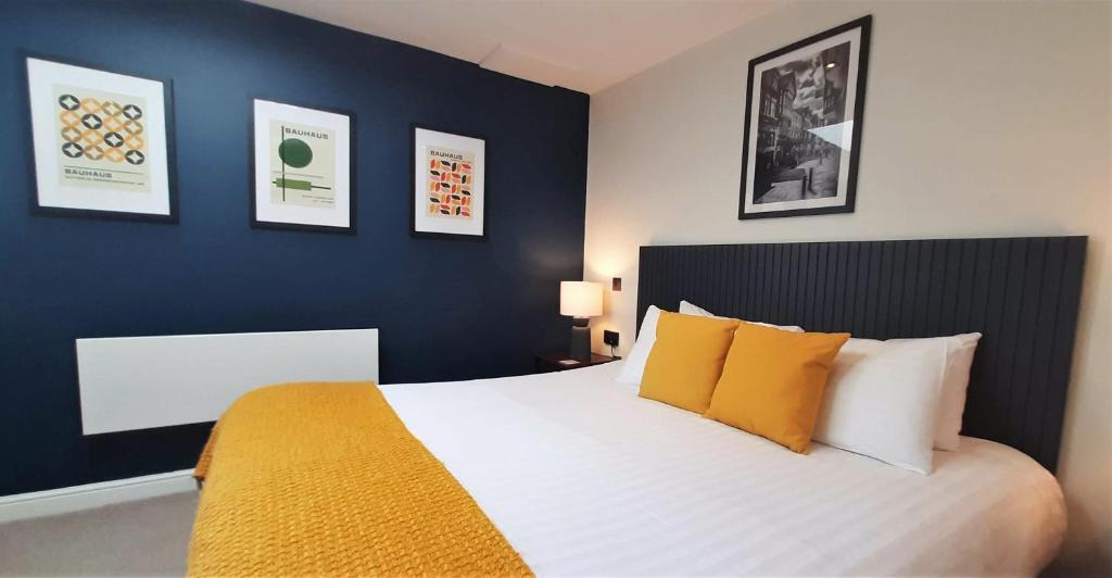 a bedroom with a large white bed with yellow pillows at Deva Leisure in Chester