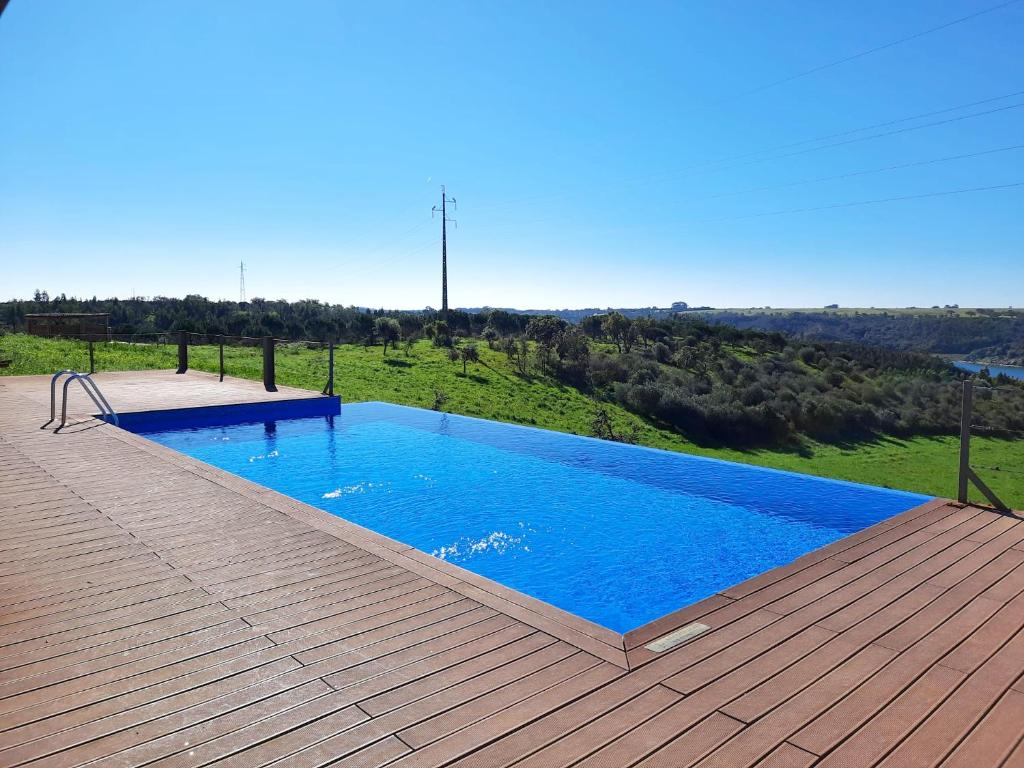 a large swimming pool on a wooden deck at Naturarte Rio - Duna Parque Resorts & Hotels in Vila Nova de Milfontes