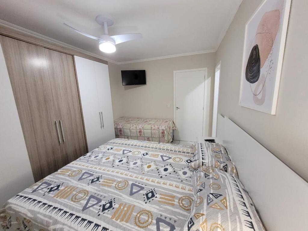 ein kleines Schlafzimmer mit zwei Betten darin in der Unterkunft Excelente Casa Duplex em Tramandaí in Tramandaí