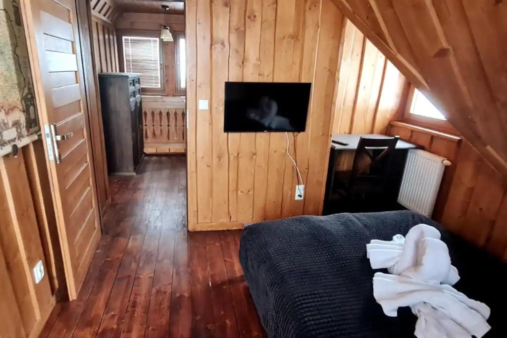 Televízia a/alebo spoločenská miestnosť v ubytovaní Domek TatrApart