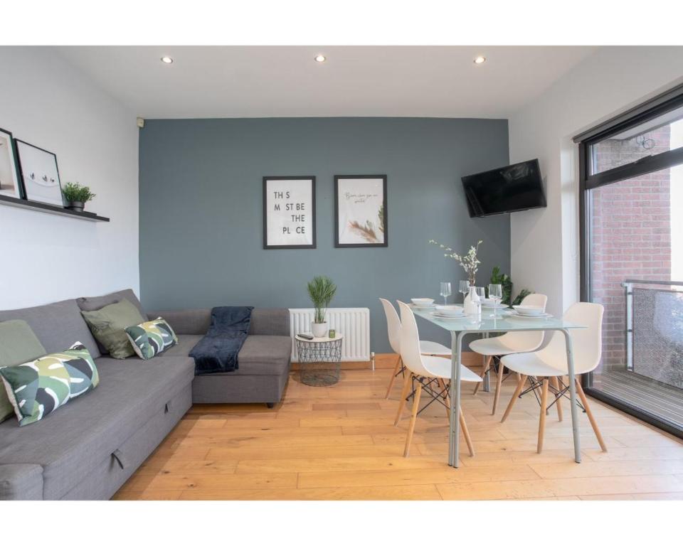 a living room with a couch and a table at Central Belfast Apartments Eden in Belfast
