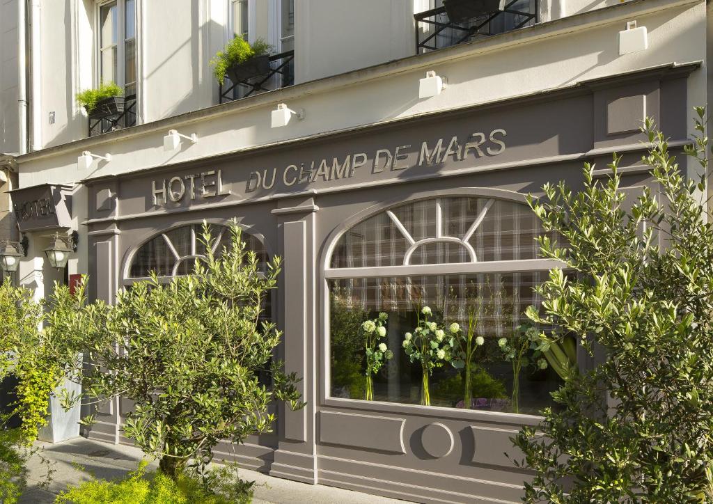 a store front of a building with a window at Hotel du Champ de Mars in Paris