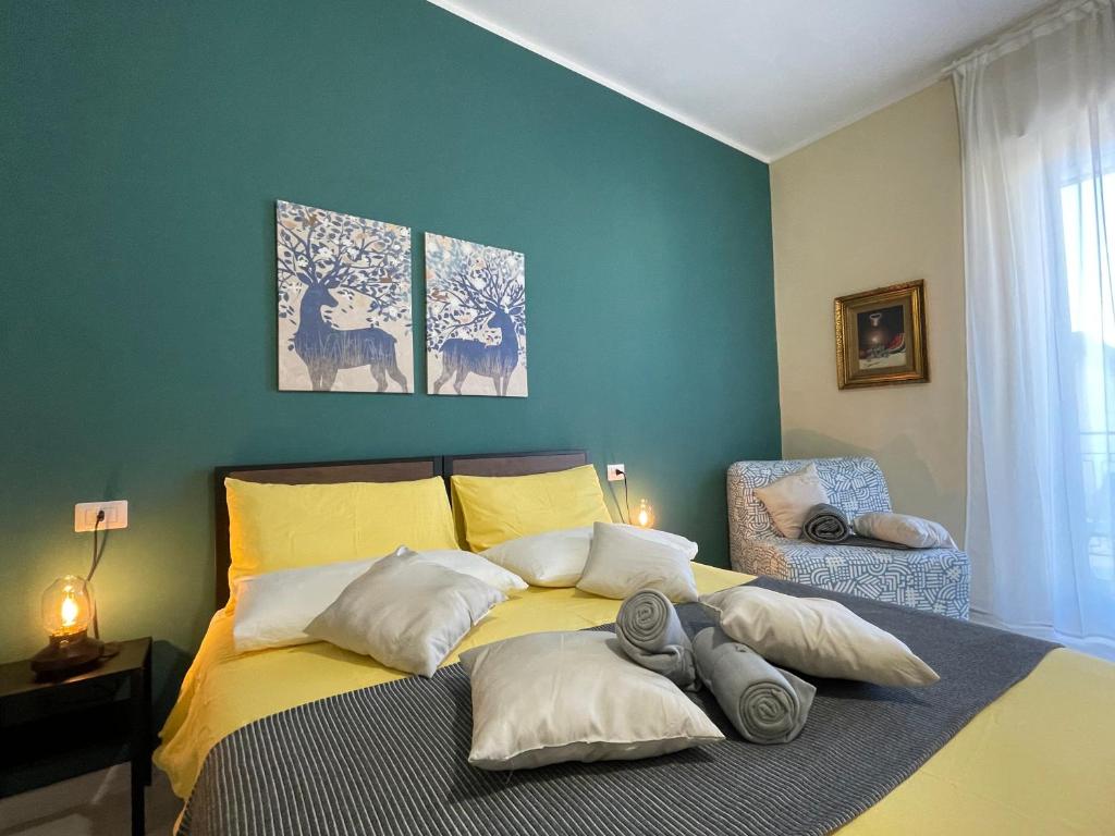 a bedroom with a yellow bed with two pillows at B&B D'Aponte Home in Volla