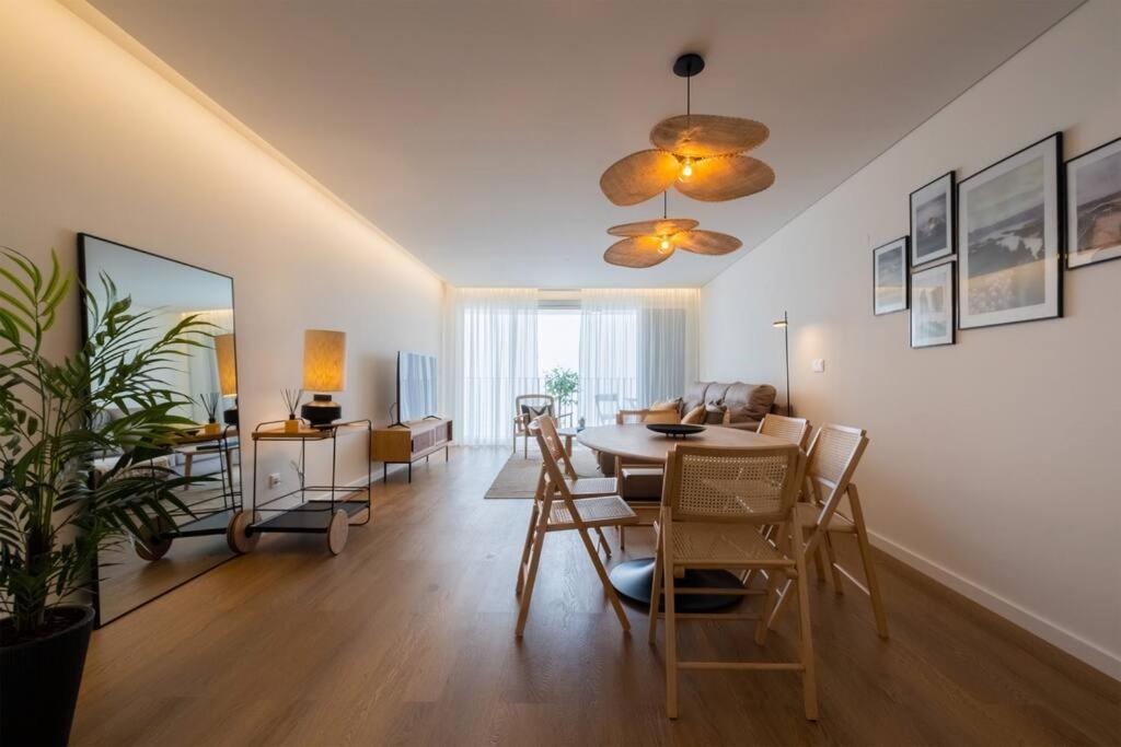 a living room with a dining table and a living room at Island Retreat Apt (city center) in Ponta Delgada