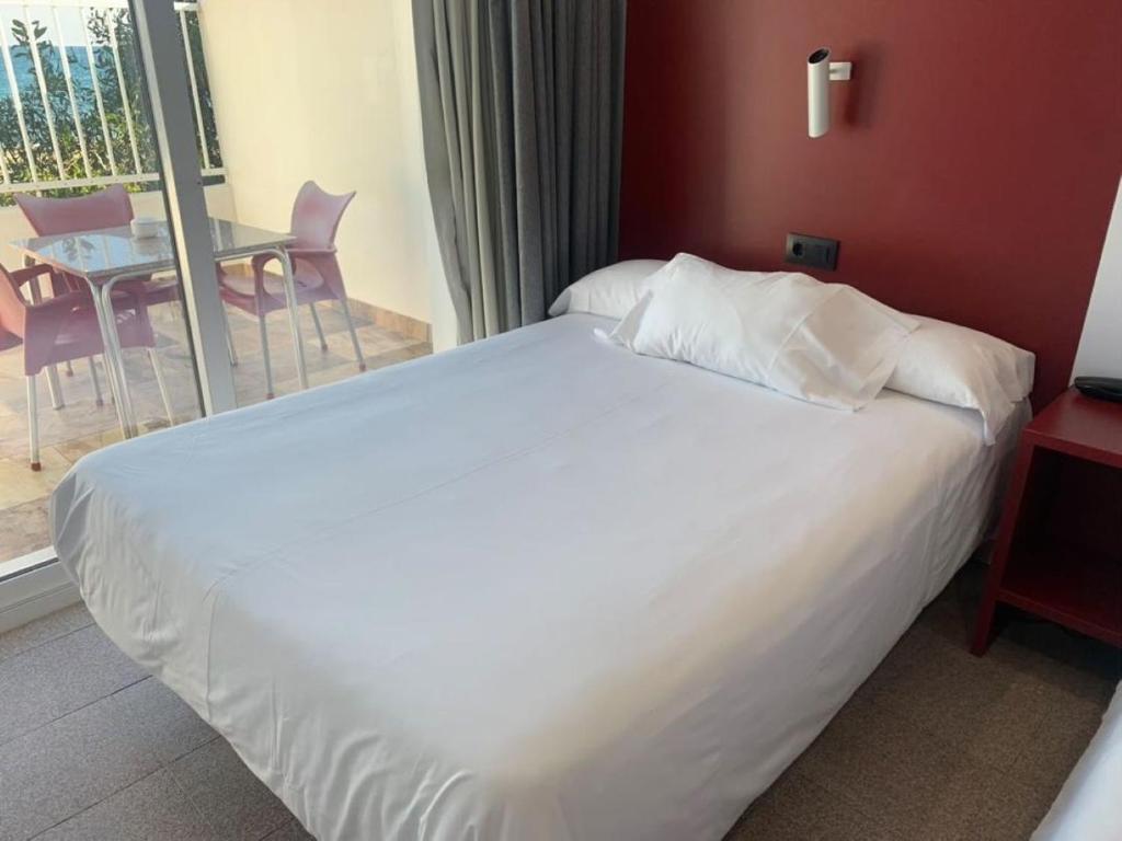 Postel nebo postele na pokoji v ubytování Hospedium Hotel Continental