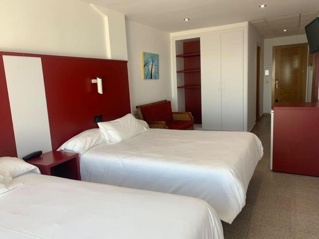 Postel nebo postele na pokoji v ubytování Hospedium Hotel Continental