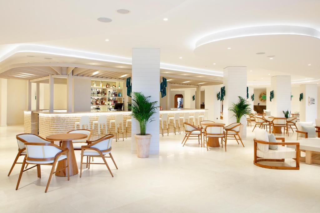 a restaurant with tables and chairs and a bar at The Signature Level at TRS Ibiza Hotel - All Inclusive Adults Only - Entrance to Clubs included in San Antonio