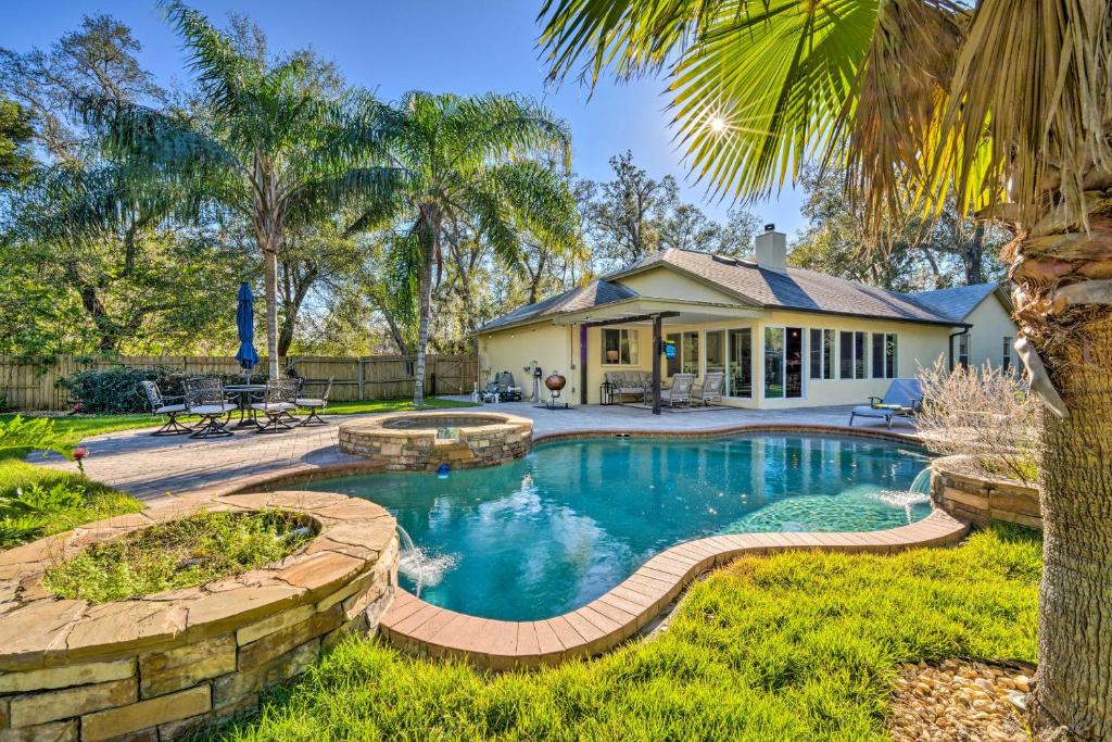a swimming pool in a yard with a house at Pet-Friendly Central Florida Home with Pool! in Lake Mary