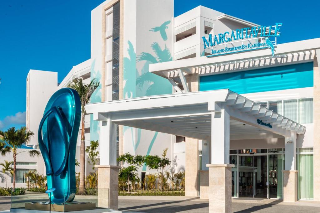 a hotel with a blue dolphin in front of a building at Margaritaville Beach Resort Cap Cana Hammock - An Adults Only All-Inclusive Experience in Punta Cana