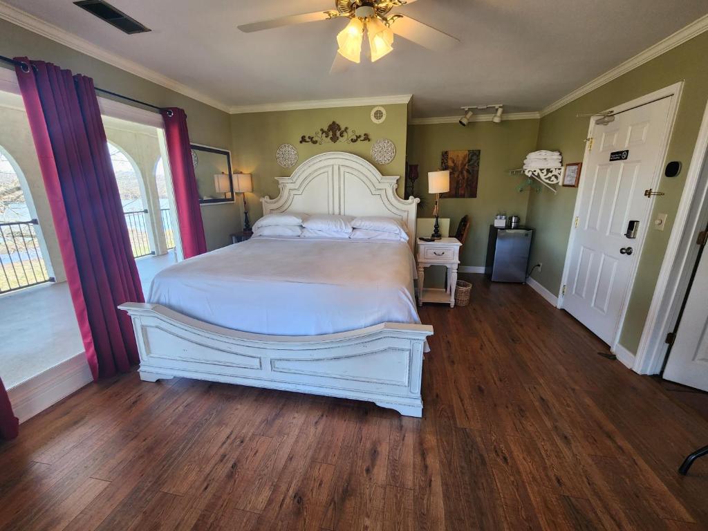 a bedroom with a white bed and a ceiling fan at Williams Island Room at Tennessee RiverPlace in Chattanooga