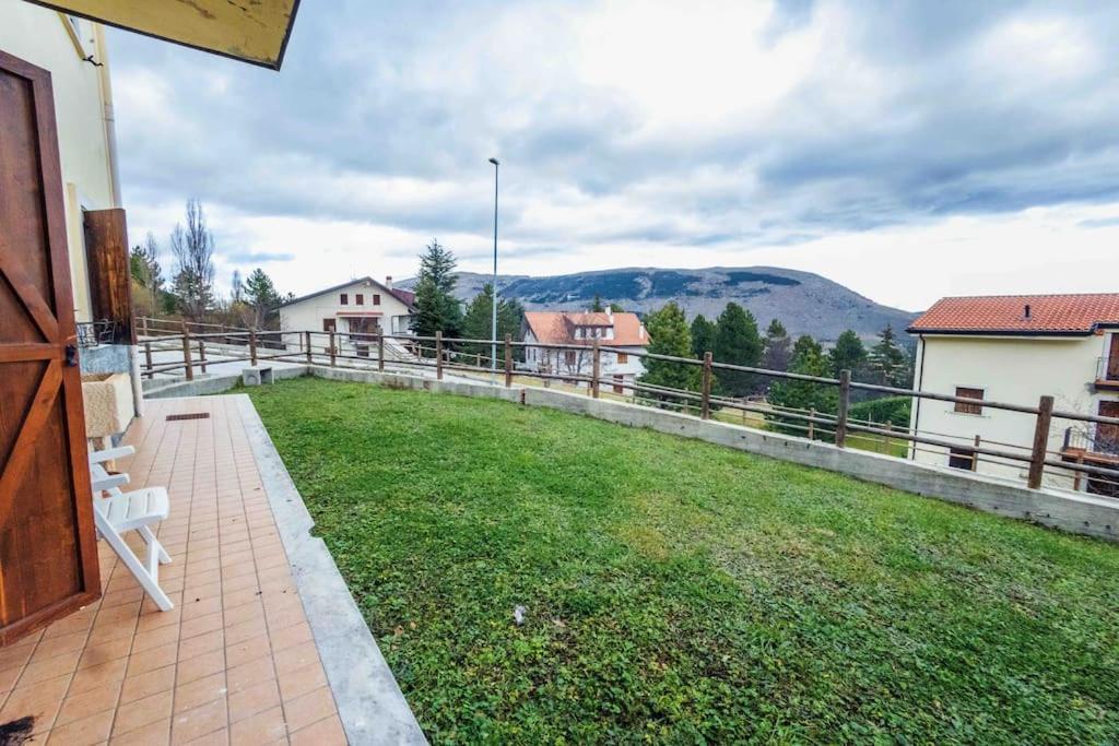 a balcony with a view of a field of grass at Maison Bruno in Pescocostanzo