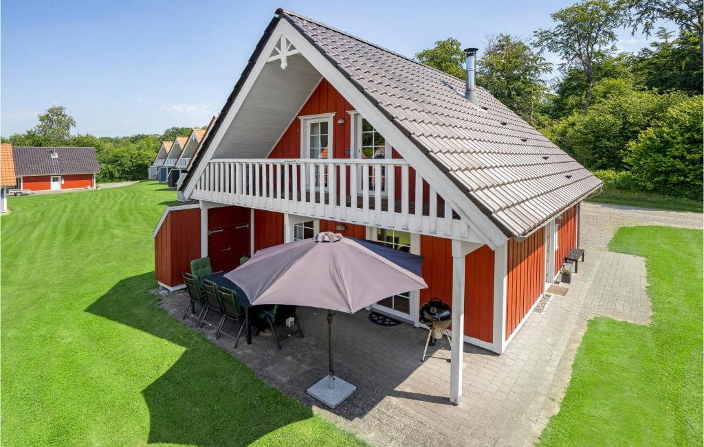 an overhead view of a red house with an umbrella at Stunning Home In Grsten With Sauna in Gråsten