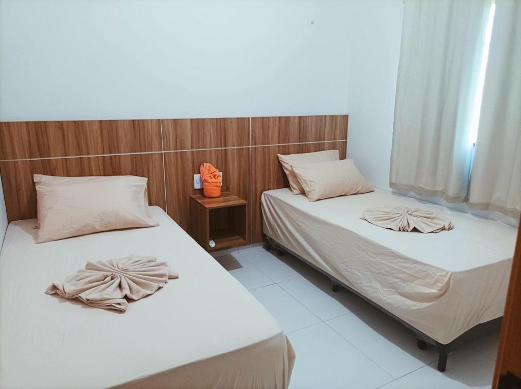 Ένα ή περισσότερα κρεβάτια σε δωμάτιο στο Apartamento nos Lençóis Confort