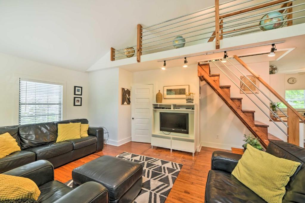 a living room with a couch and a staircase at Modern St Elmo Cottage by Lookout Mtn and Near Dwtn in Chattanooga