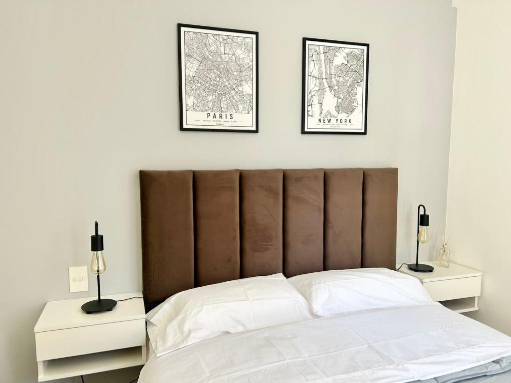 a bedroom with a large bed with two night stands at Plaza Caviahue Apartment in Neuquén