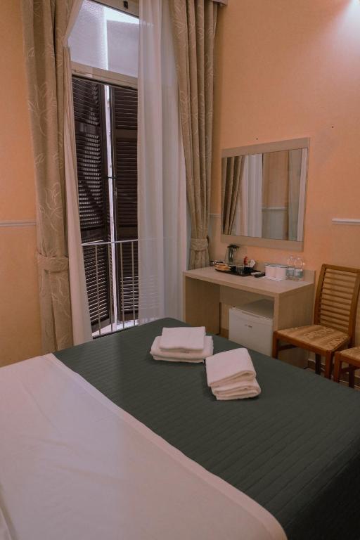 Postel nebo postele na pokoji v ubytování Hotel Aristotele