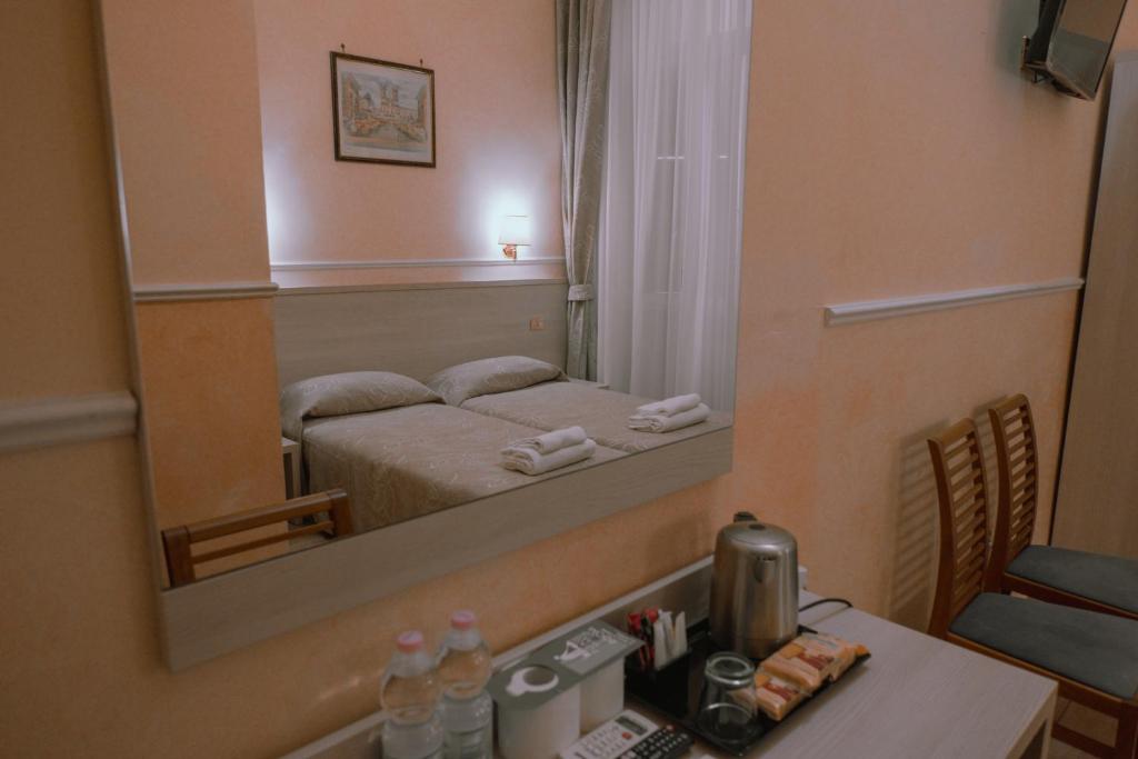 Postel nebo postele na pokoji v ubytování Hotel Aristotele