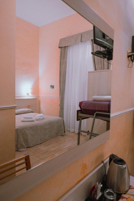 Postel nebo postele na pokoji v ubytování Hotel Aristotele