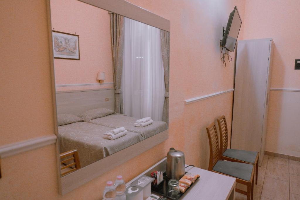 Postel nebo postele na pokoji v ubytování Hotel Aristotele