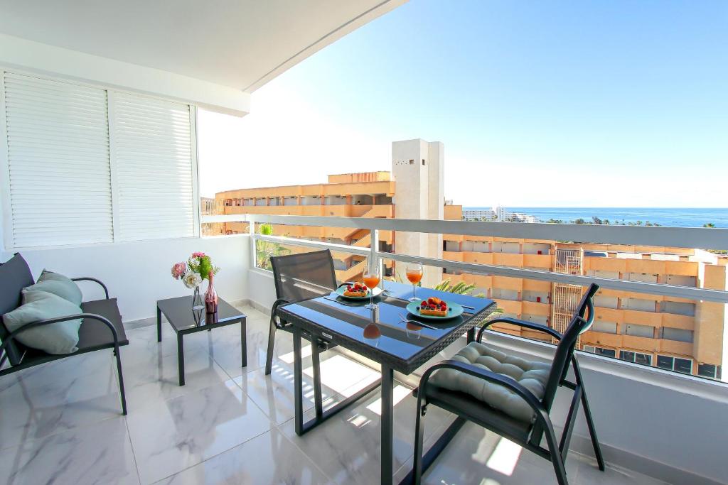 balcone con tavolo e sedie. di SEA LA VIE Ponderosa 617 a Playa Fañabe