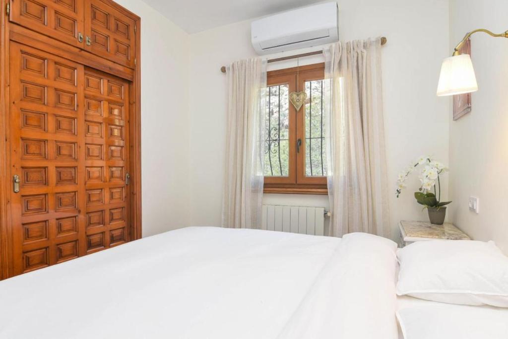 Postel nebo postele na pokoji v ubytování Villa Encinas