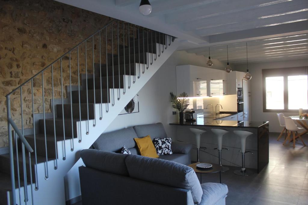 een woonkamer met een bank en een trap bij CASA RURAL MENSIN in Villar de Canes
