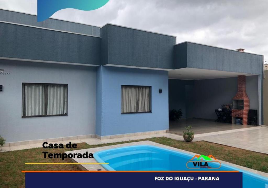 una casa con piscina frente a ella en Casa maravilhosa c/piscina bourb, en Foz do Iguaçu