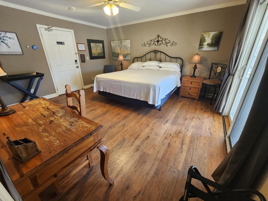 a bedroom with a bed and a wooden floor at Elder Mountain Room at Tennessee RiverPlace in Chattanooga