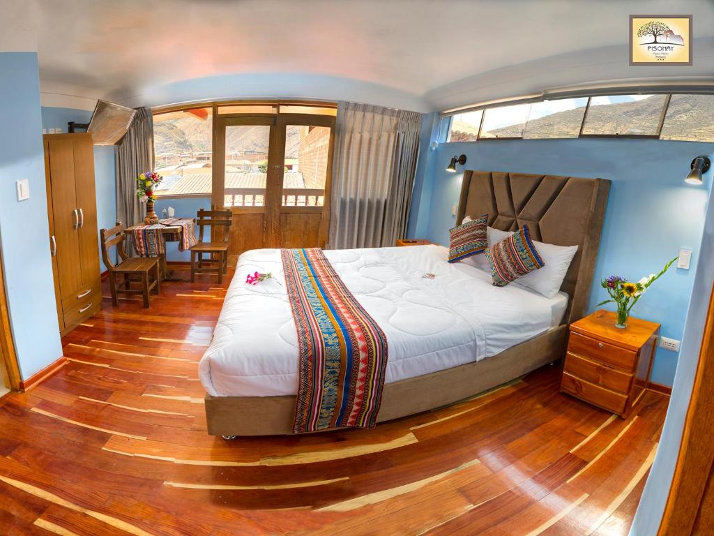 Postel nebo postele na pokoji v ubytování Pisonay Hotel