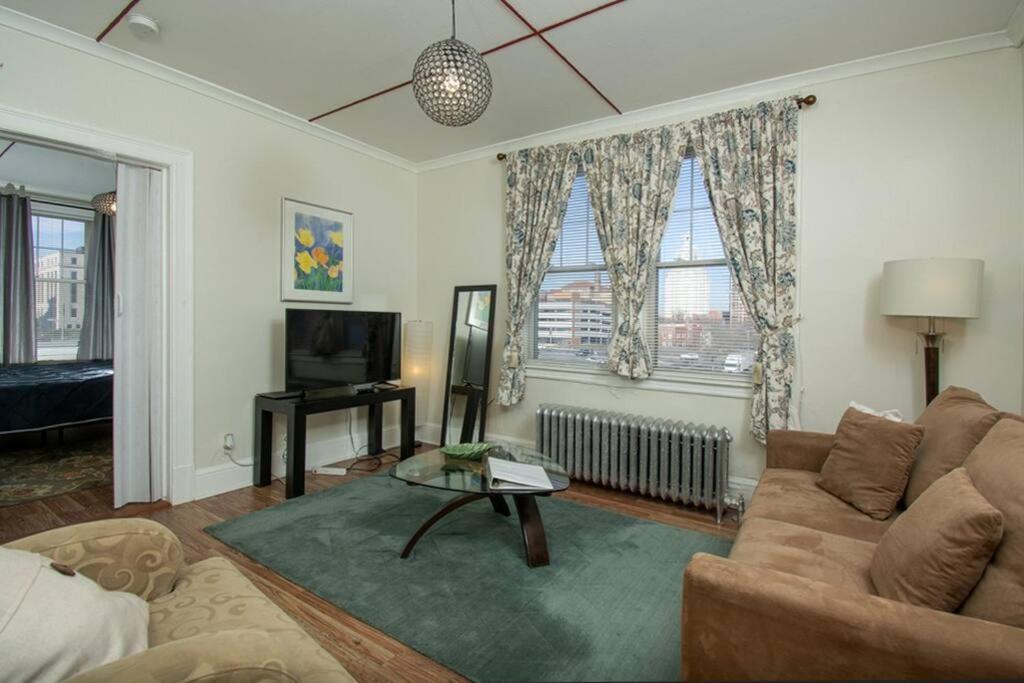 a living room with a couch and a tv at The Bushnell Suite C2 in Hartford