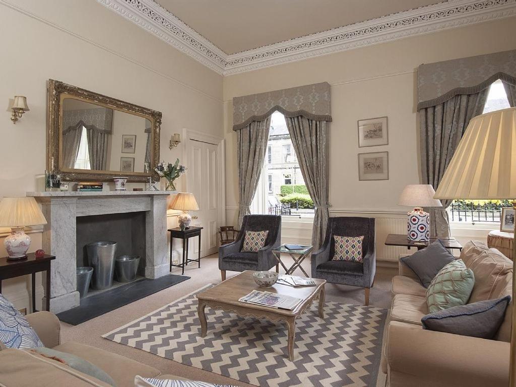 a living room with a couch and a fireplace at 1 Bellevue Terrace in Edinburgh