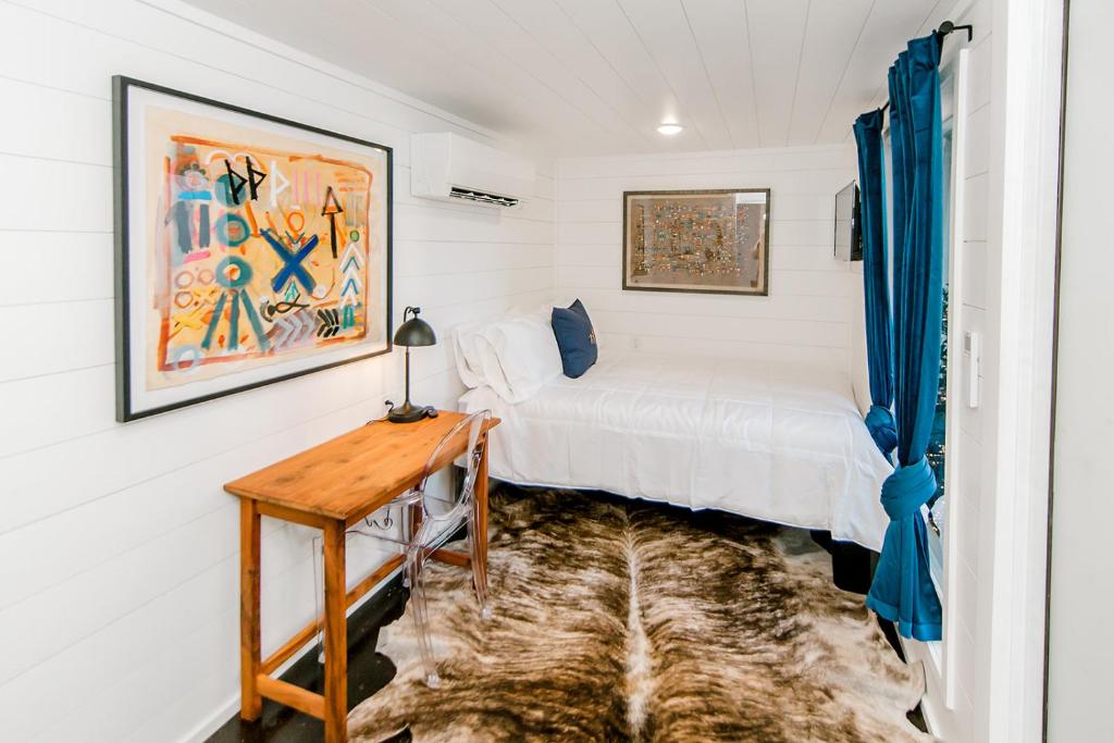 a bedroom with a bed and a wooden table at The Middleton Hotel in Graham