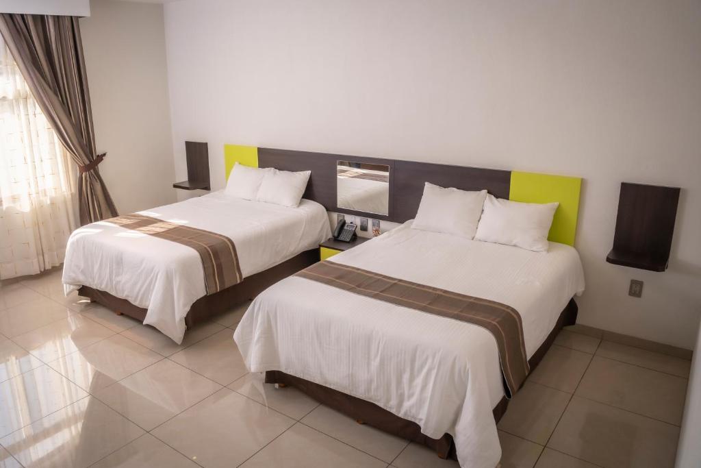 Postel nebo postele na pokoji v ubytování Hotel SanJo