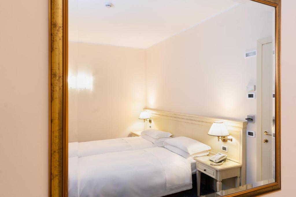 Postel nebo postele na pokoji v ubytování Hotel Alle Acque