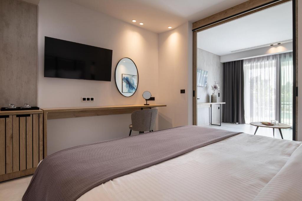 A bed or beds in a room at Lagomandra Luxury Suites with Private Pools