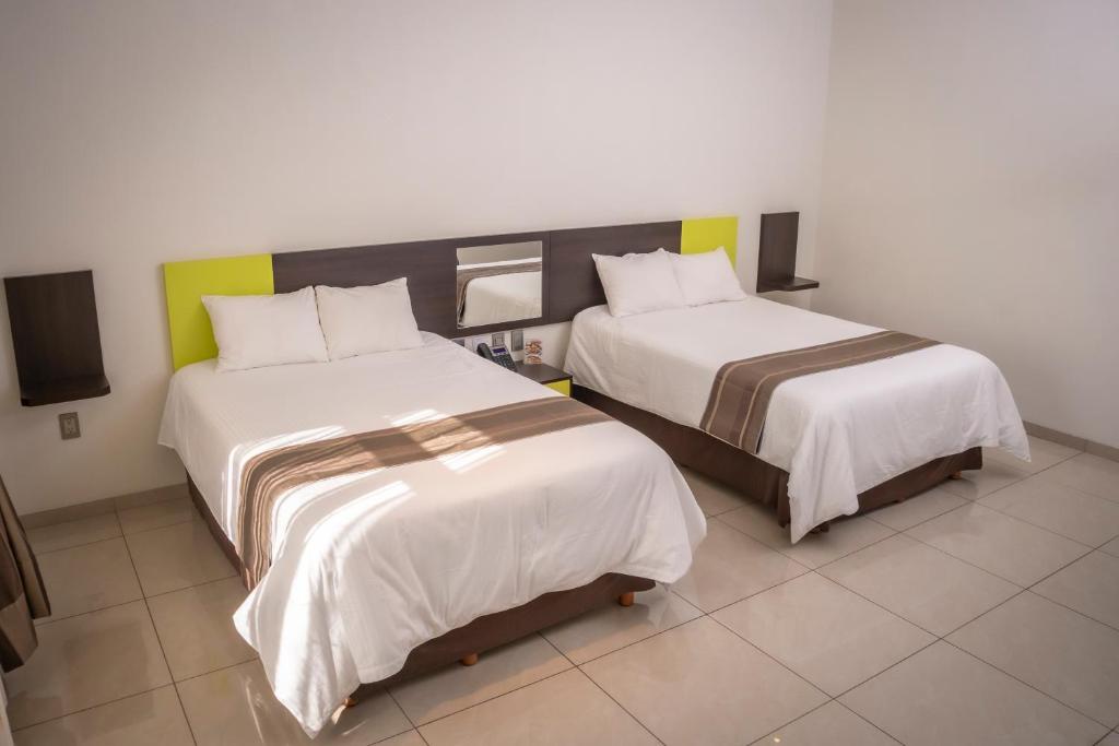 Postel nebo postele na pokoji v ubytování Hotel SanJo