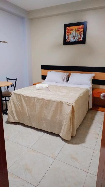 Postel nebo postele na pokoji v ubytování Hostal Parisuite