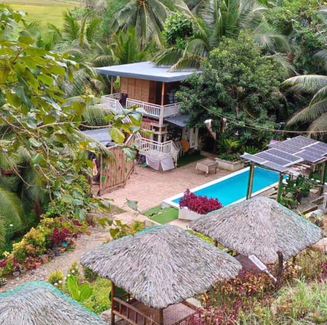 an aerial view of a house with a swimming pool at JKO woodland resort in Malampay