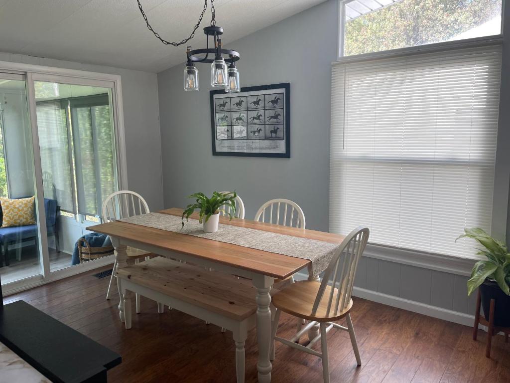 a dining room with a wooden table and chairs at Bright 3bdrm perfect location 2.5 mi to SPAC , Close to track, downtown and Saratoga hospital in Ballston Spa