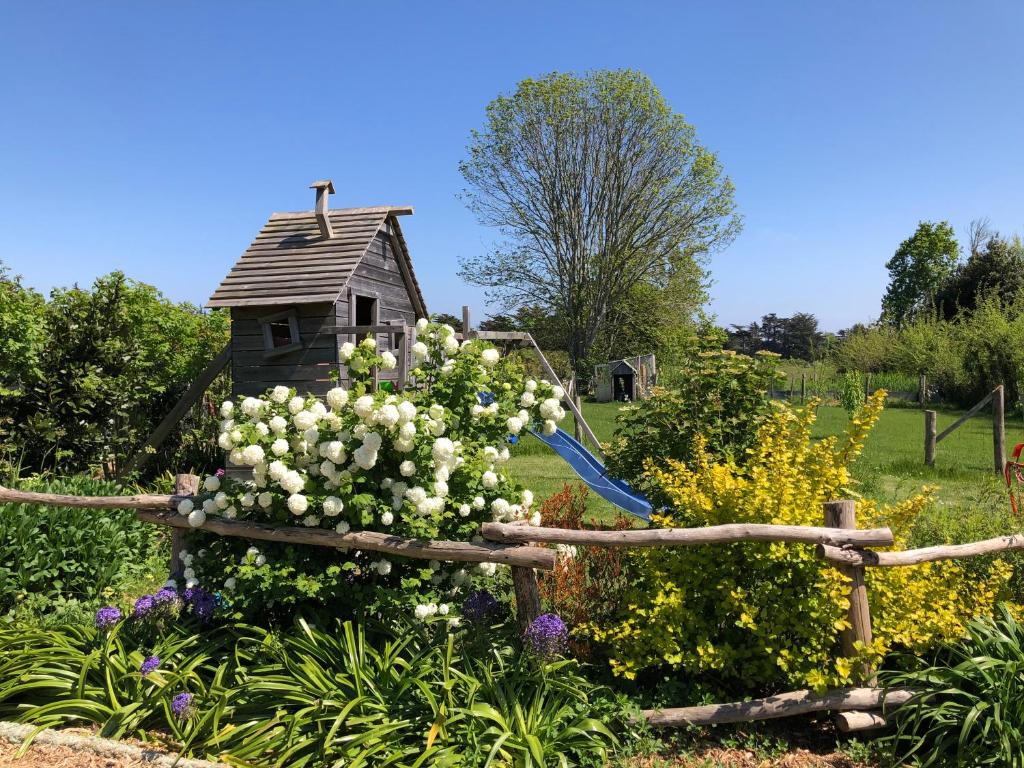 a garden with a wooden fence with a bunch of flowers at Les Chambres d&#39;Hôtes de Bordustard in Le Palais