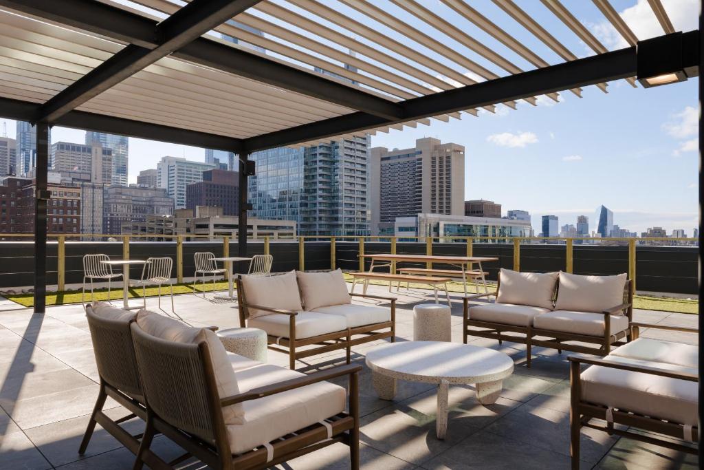 a patio with chairs and tables and a view of the city at Sonder Onyx in Philadelphia