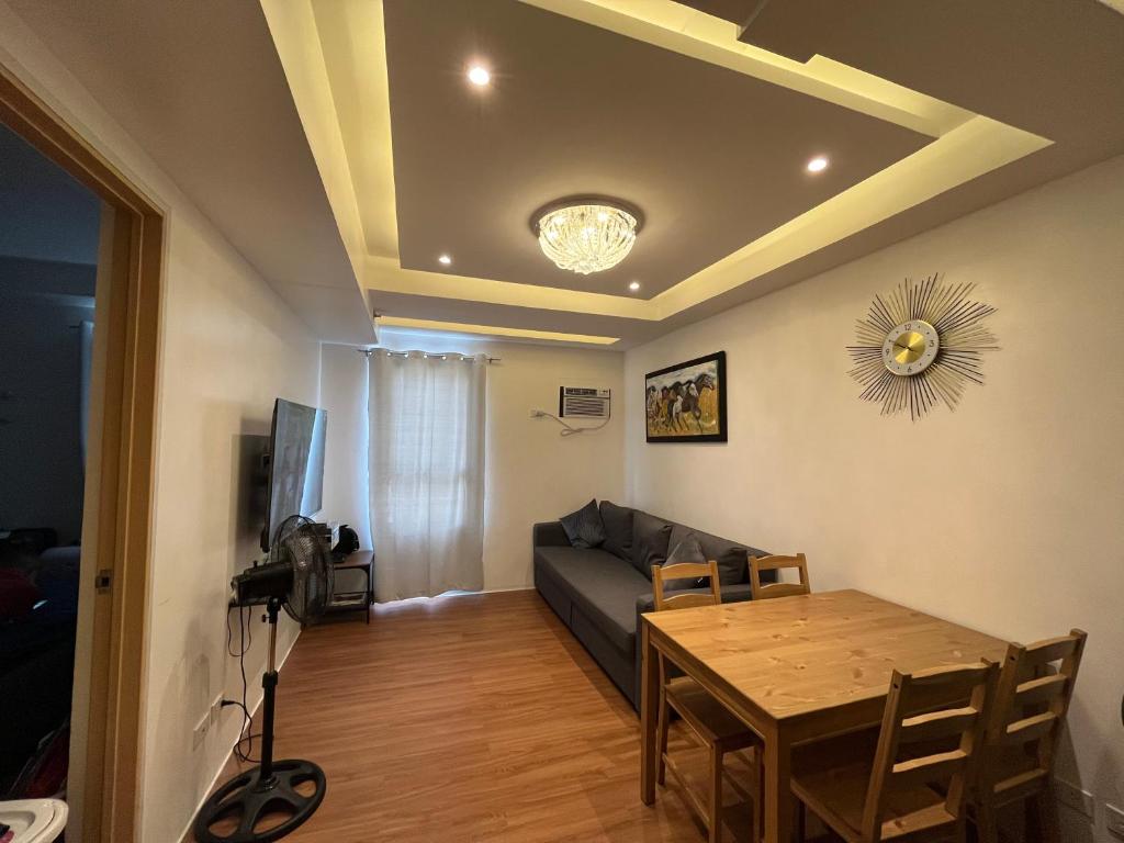 a living room with a couch and a table at The Cozy Place Condo in Pasig Phil in Manila