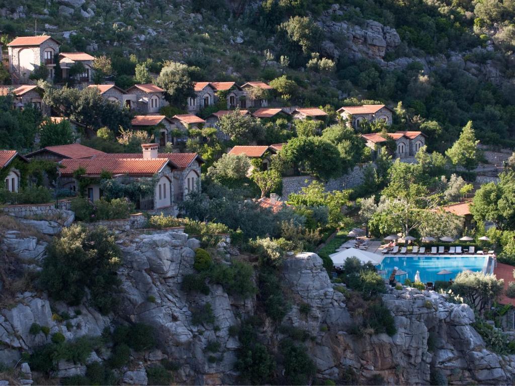 a house on a mountain with a swimming pool at Dionysos Village Hotel Marmaris in Turunç