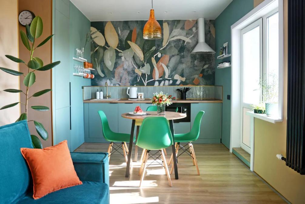 a dining room with a table and green chairs at Cozy two-room apartment in Istanbul