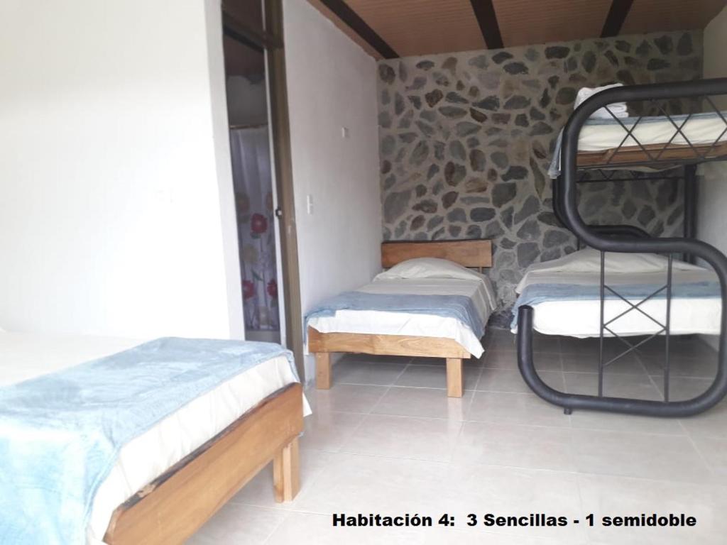 Postel nebo postele na pokoji v ubytování El Guadual Casa Campestre