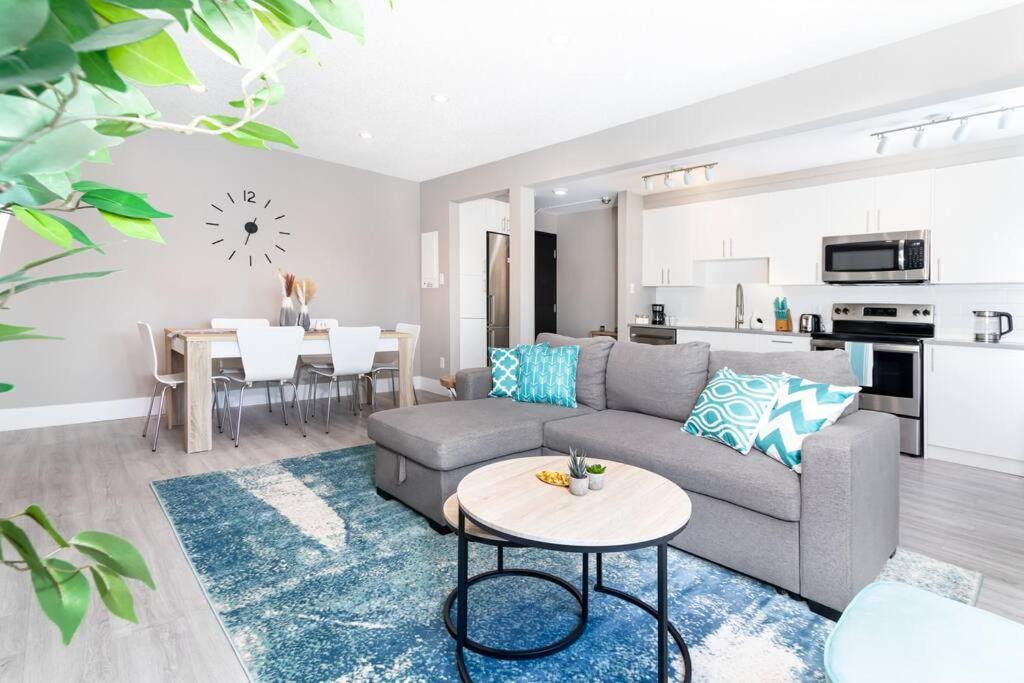 a living room with a couch and a table at Modern & Stylish 2-Bedroom Unit in Edmonton