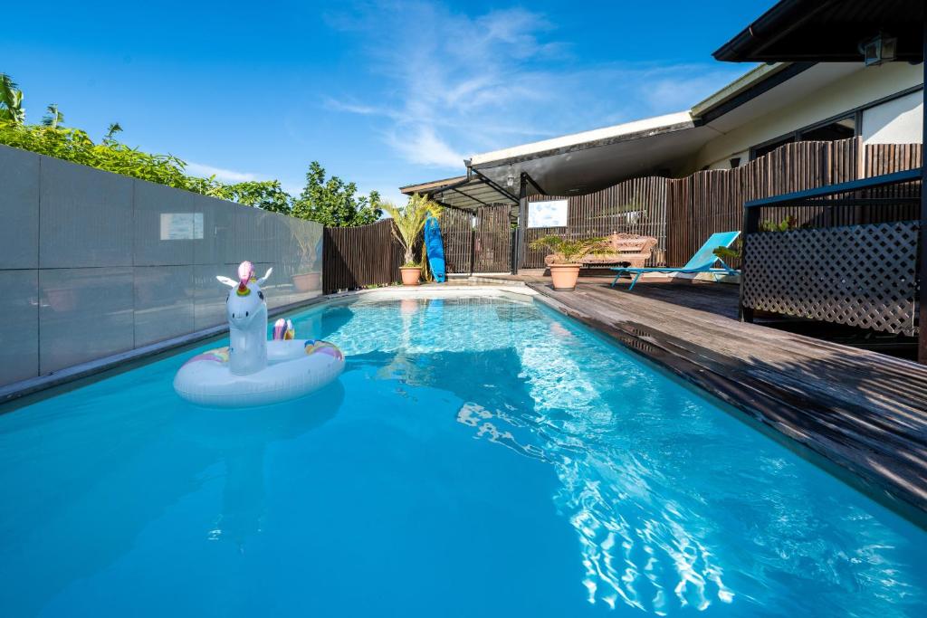 a swimming pool with a pool noodle in the middle at KIA ORA LODGE in Afaahiti